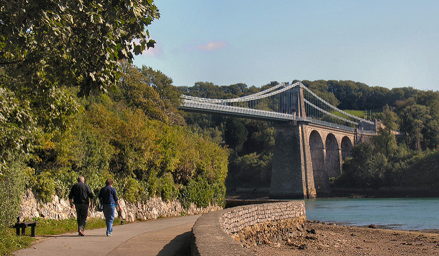 Menai Bridge with couple walking under.