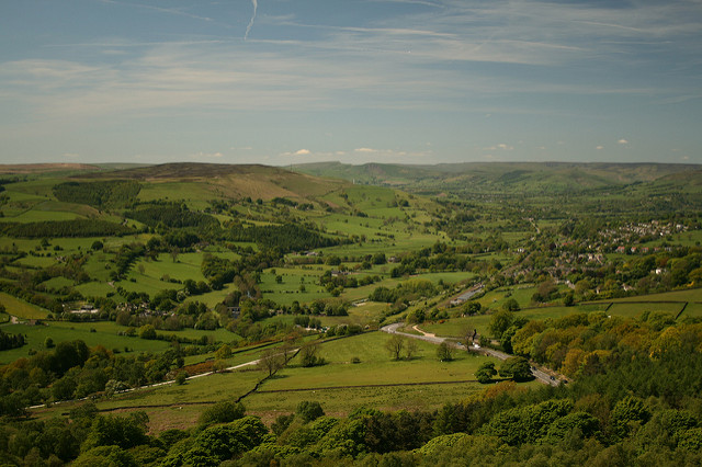 Rural England. Green fields, soft hills and blue sky.