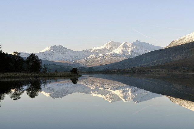 Clear lake with the snow capped mountains reflected in the waters