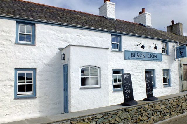 Pub with white tones walls and blue trim around the doors and windows