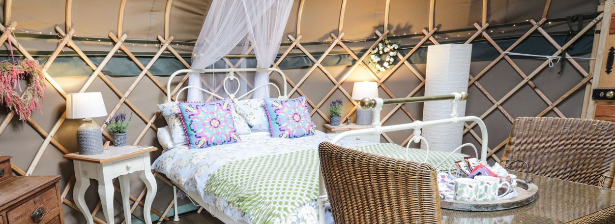 Interior of a Yurt on a Glamping site in Llangollen with double bed and dressing table