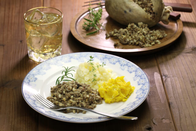 haggis neeps and tatties on a white plate