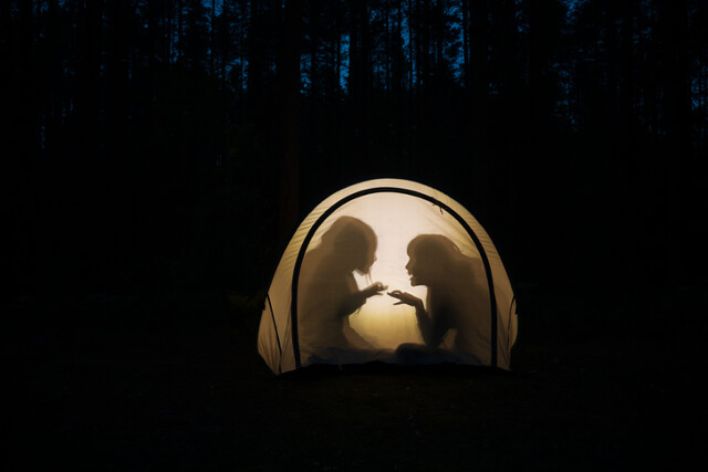 playing in a tent at night time