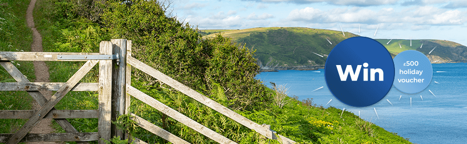 Close up of wooden gate on a coastal path with seascapes in the background