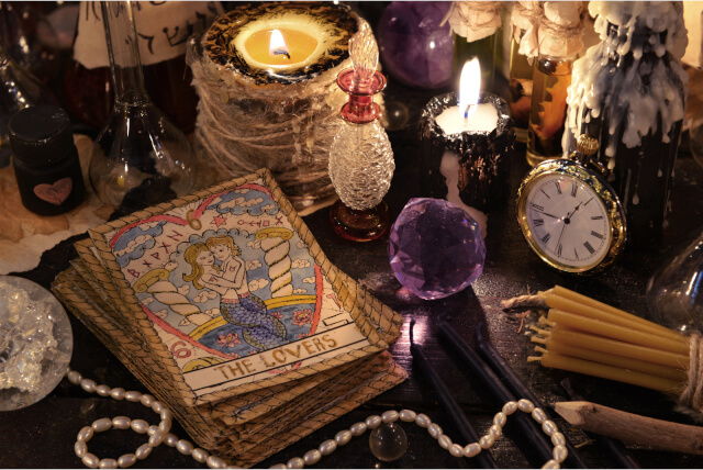 tarot cards with crystal, candles and magic objects