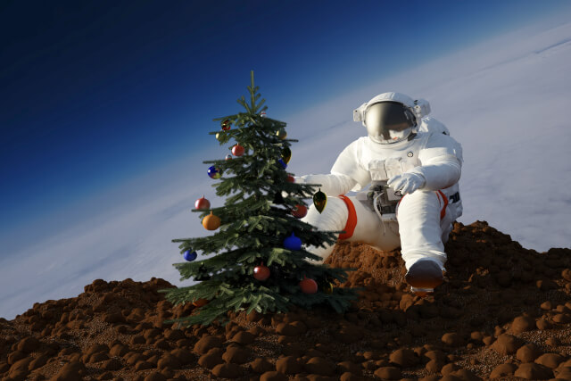 astronaut in space with christmas tree