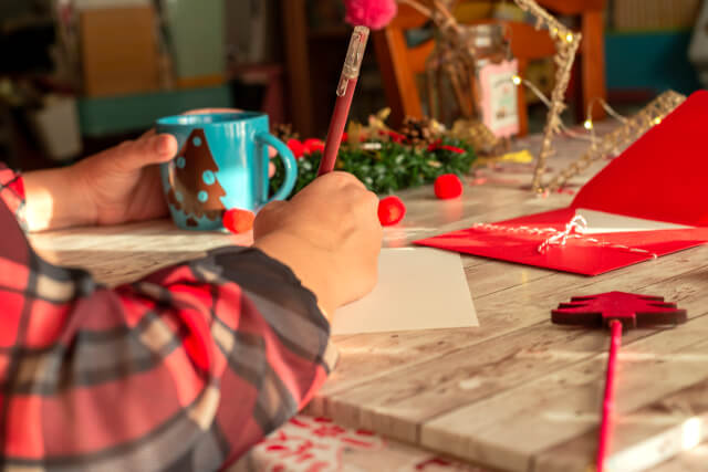 woman writing christmas card