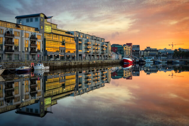 Galway, morning view on Dock with boats reflected in water