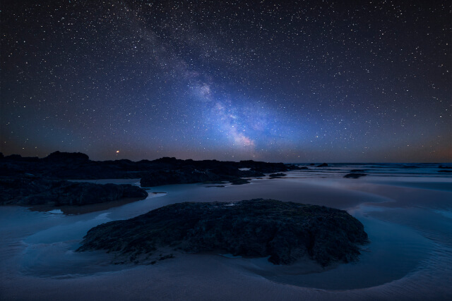 Milky Way over landscape of Freshwater West beach on Pembrokeshire Coast