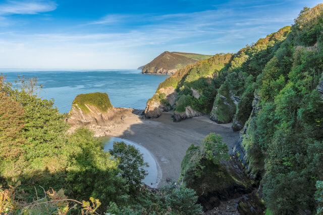 Broadsands beach enveloped in cliffs and greenery