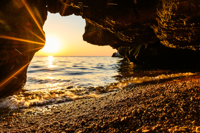 A tunnel on the beach looking out onto the sea