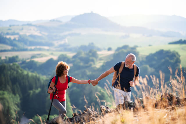 Adults walking uphill countryside