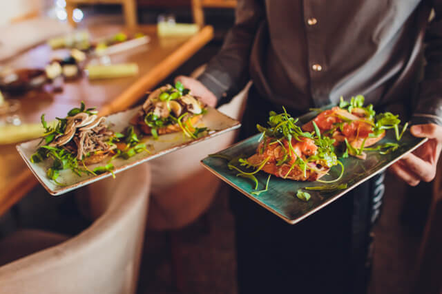 Two meat plate in waiter's hand