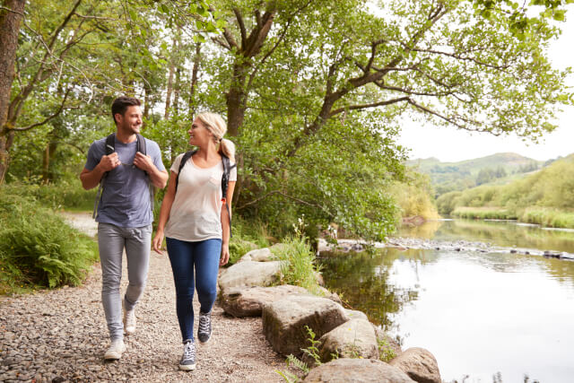 Couple walking by a river