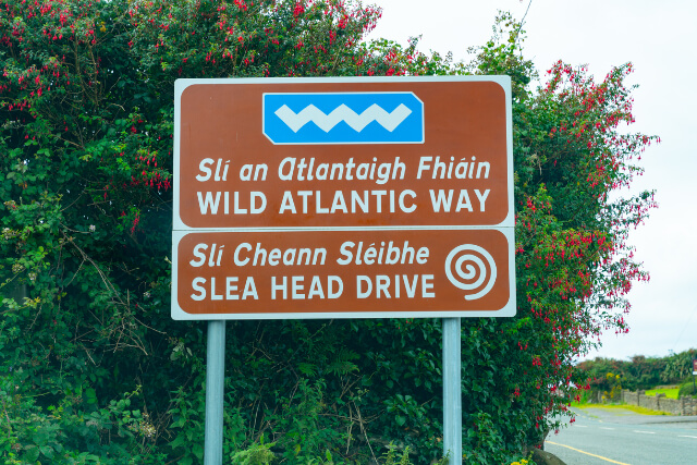 Highway sign for Wild Atlantic Way in two languages, Gaelic and English