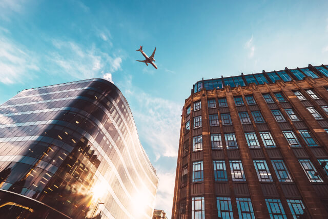 Jet plane flying over Glasgow city buildings 