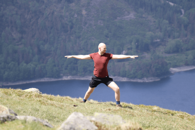 Man doing yoga on Helvellyn in the Lake District