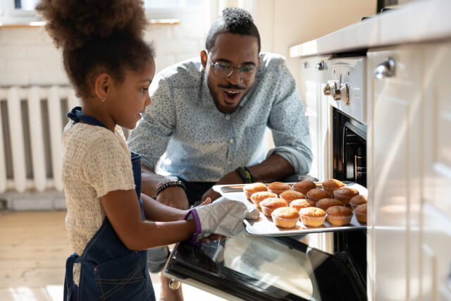 Dad and daughter baking at home