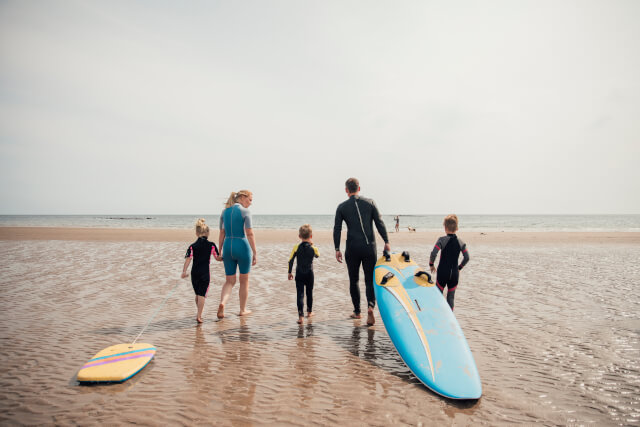Family surfing at the beach