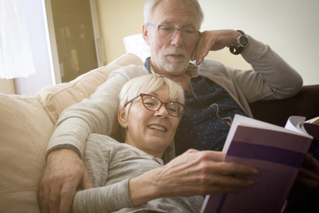 Old couple reading together 