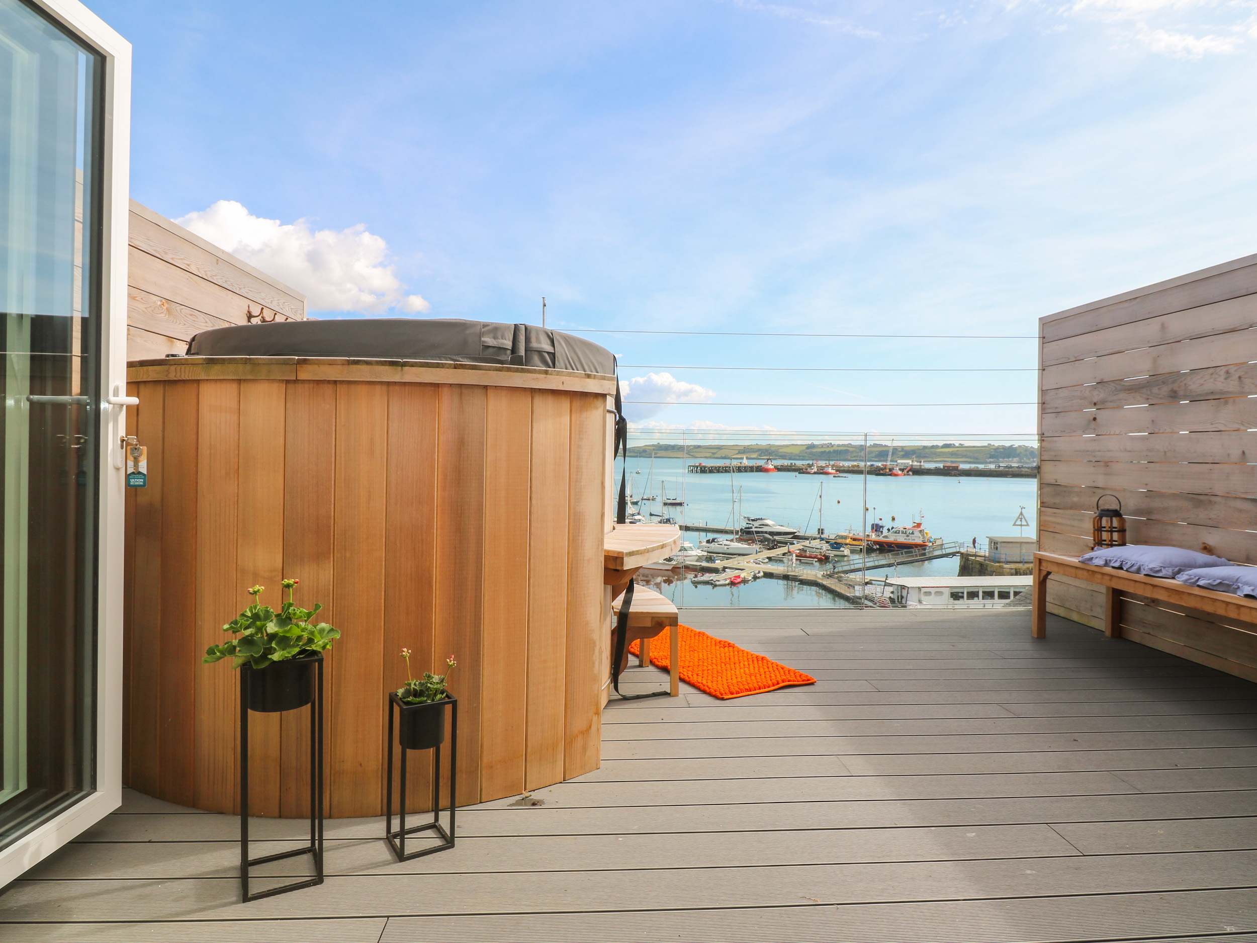 Wood-burning hot tub looking towards the harbour in Cornwall