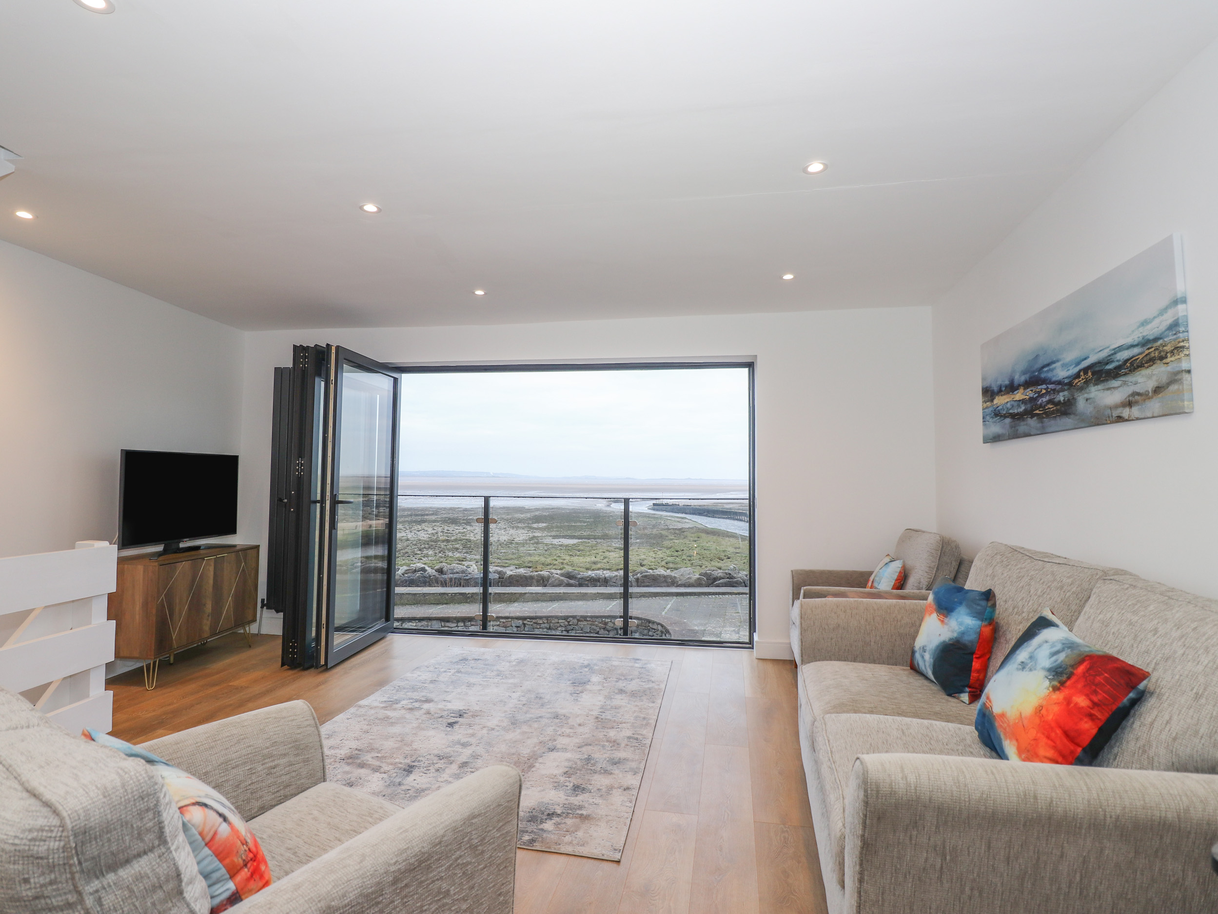 Living room with open doors looking over the coast in the Lake District