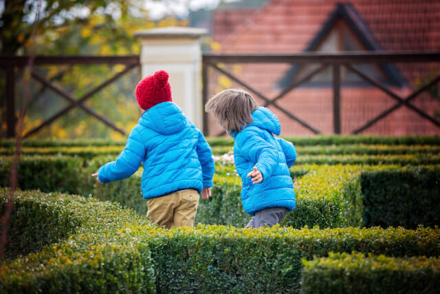 two kids exploring a maze