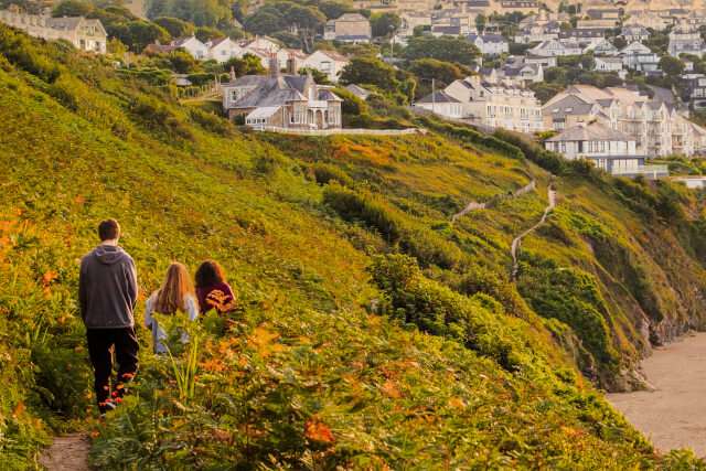 Group walking across the headland towards St Ives, Cornwall