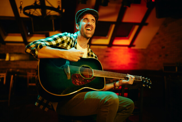 Man playing guitar in a pub