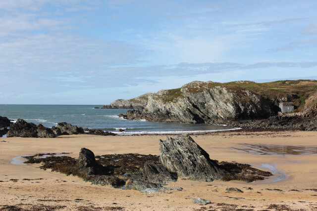 Unique rock formations sticking out of the sand at Trearddur Bay, Anglesey