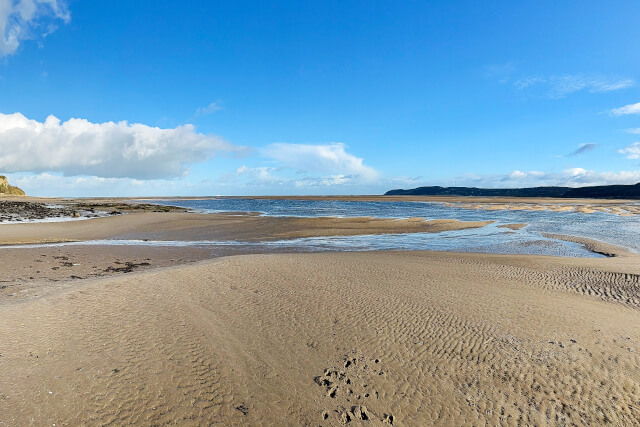 Looking east out over Red Wharf Bay, with both headlands visible to the left and right in the distance