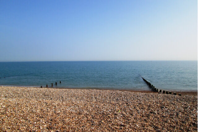 Looking out across the English channel from a pebble beach on the West Sussex coast in Southern England
