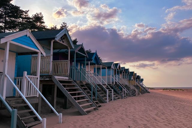 Image of colourful huts on a Norfolk beach