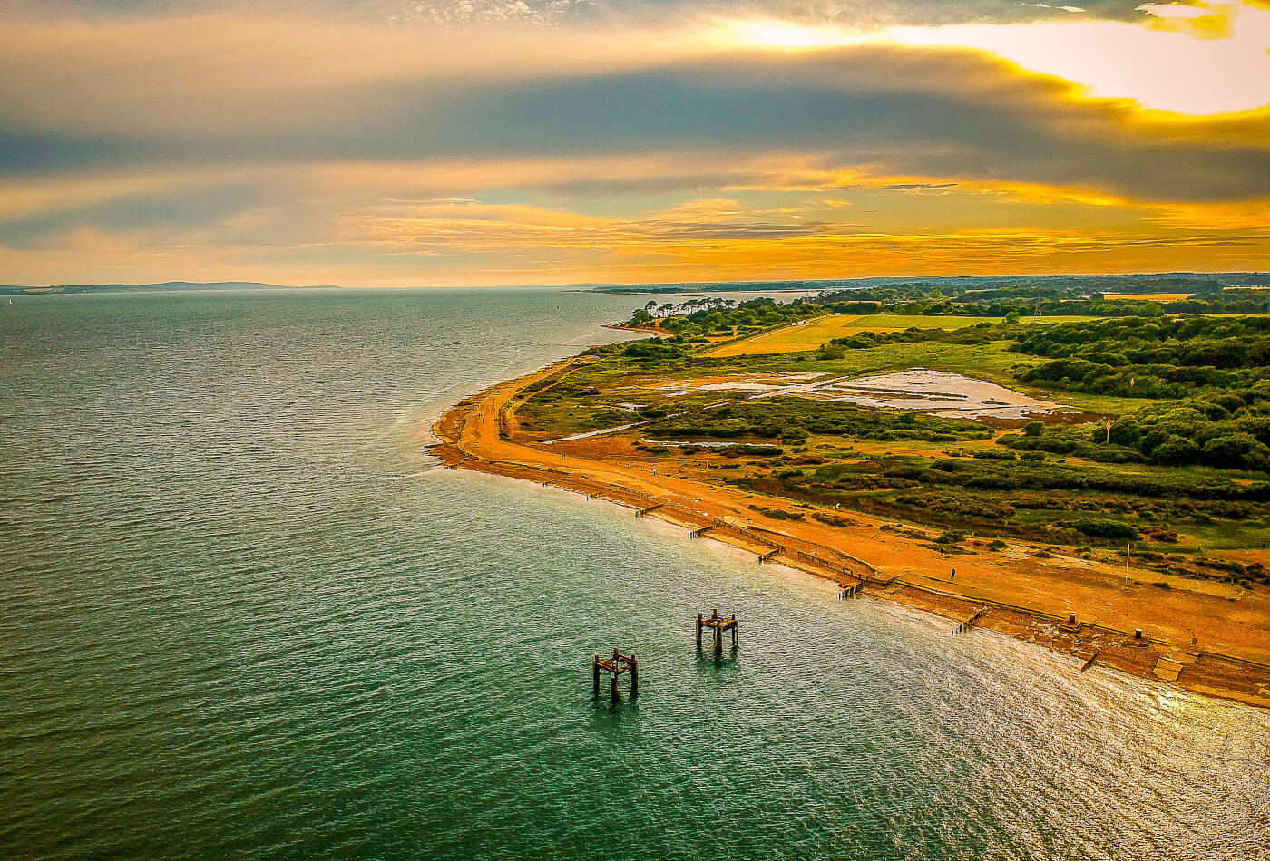 Sweeping aerial shot of a beach in Hampshire, England