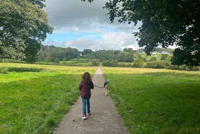 Young girl and her dog on a dog walk