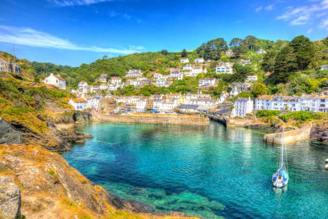 Polperro Harbour in Cornwall, with clear blue and turquoise sea in vivid colour.