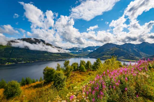 Early morning at Loch Duich in the Highlands of Scotland with low lying clouds and mountain views.