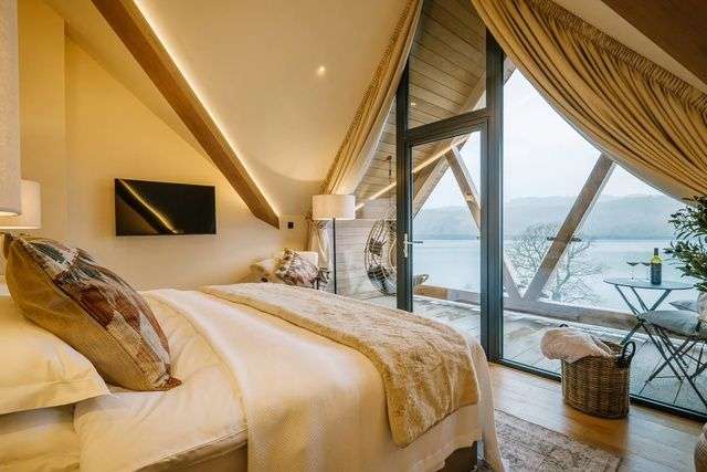 Bedroom with balcony and lake view in The Ridge.