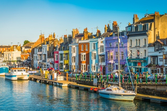 Weymouth harbour and colourful houses.