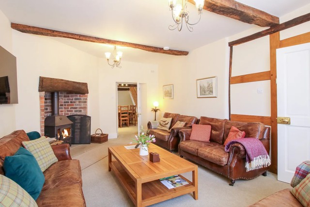 Living room with woodburning stove at The Maltster's House.
