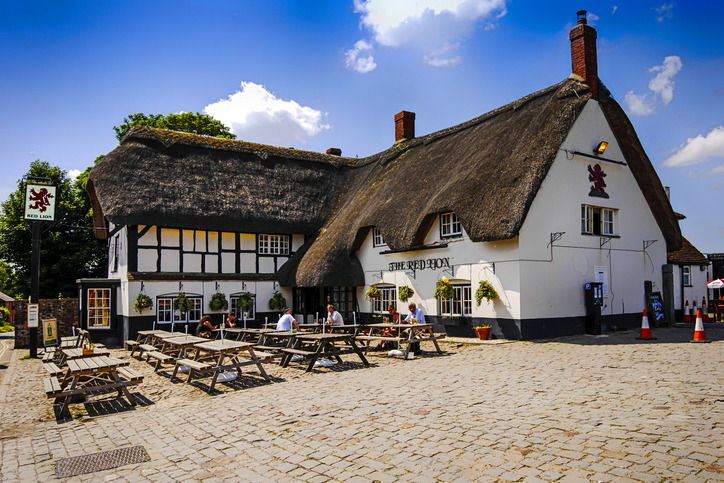 People outside the Red Lion at Avebury in Wiltshire, UK