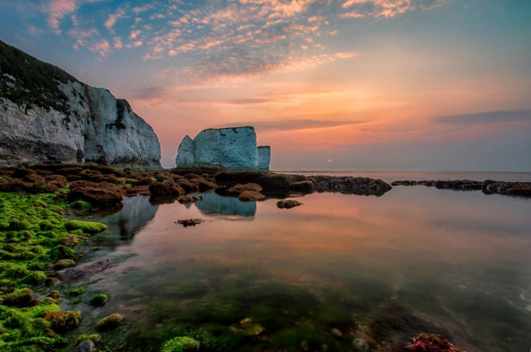 Sun rising behind Old Harry Rocks, the most easterly point of the Jurassic Coast