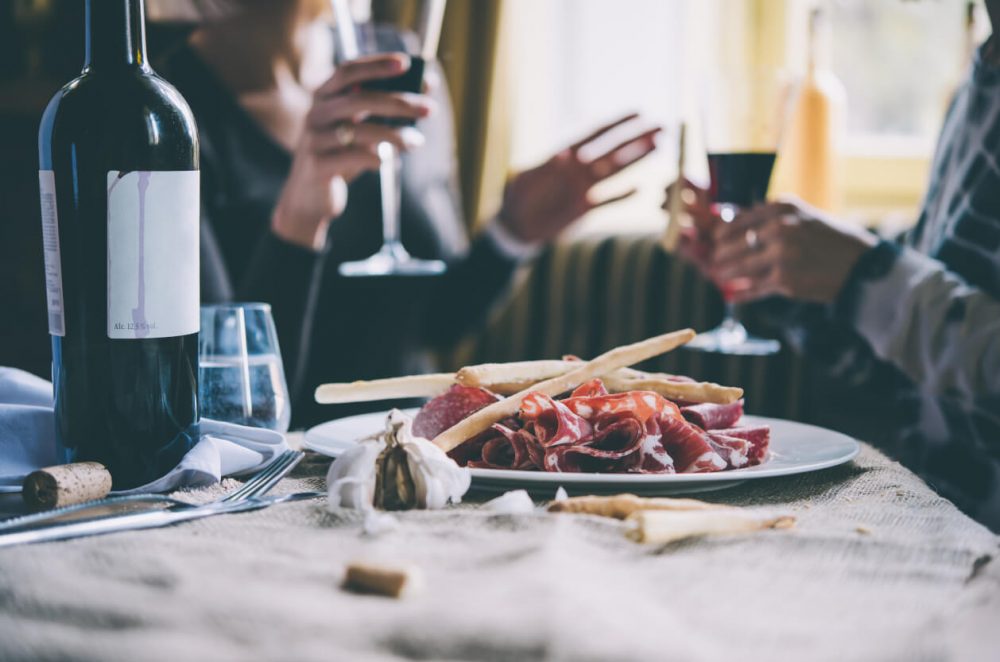 Cold meats and wine on linen table