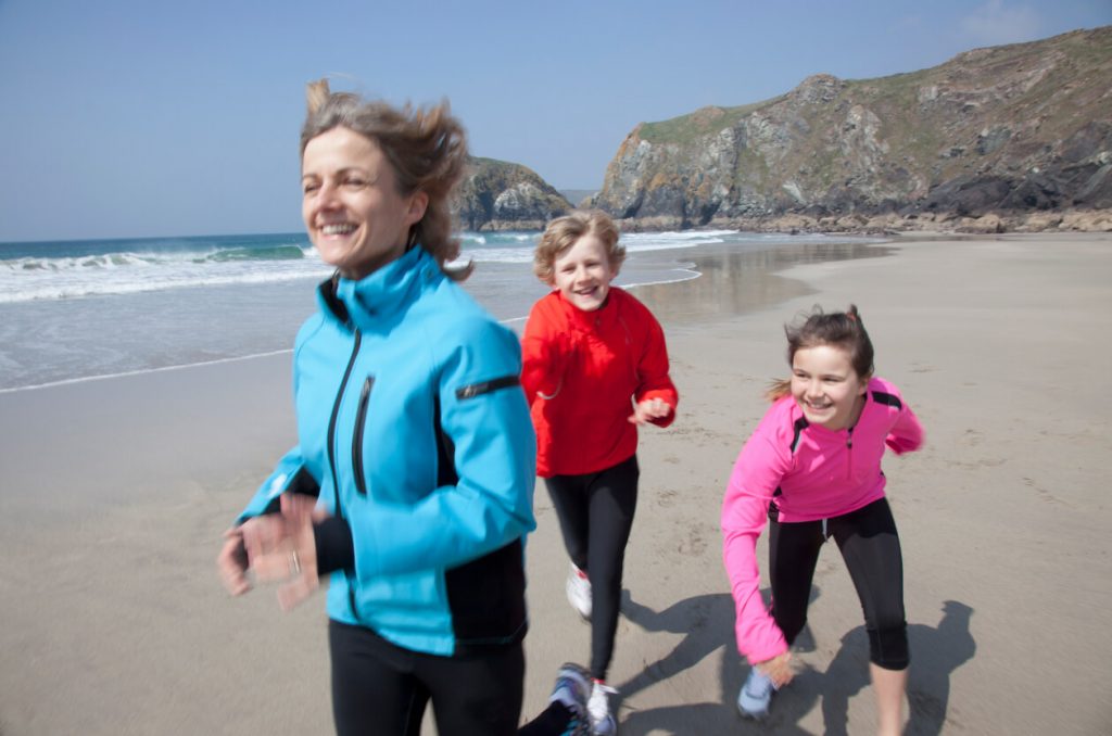 Family having fun on the beach UK