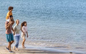 Family of four enjoying the beach