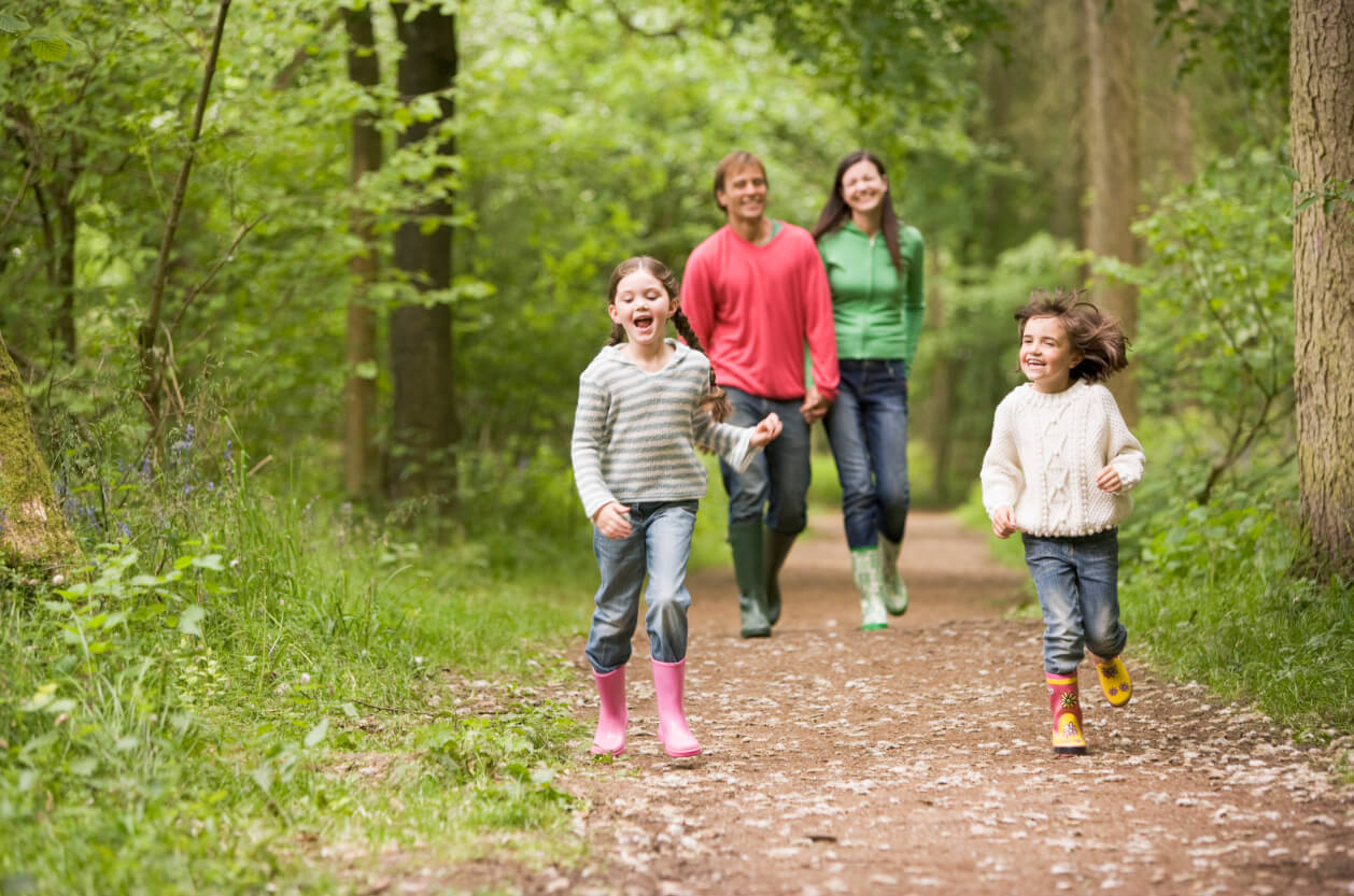 Family wandering through park