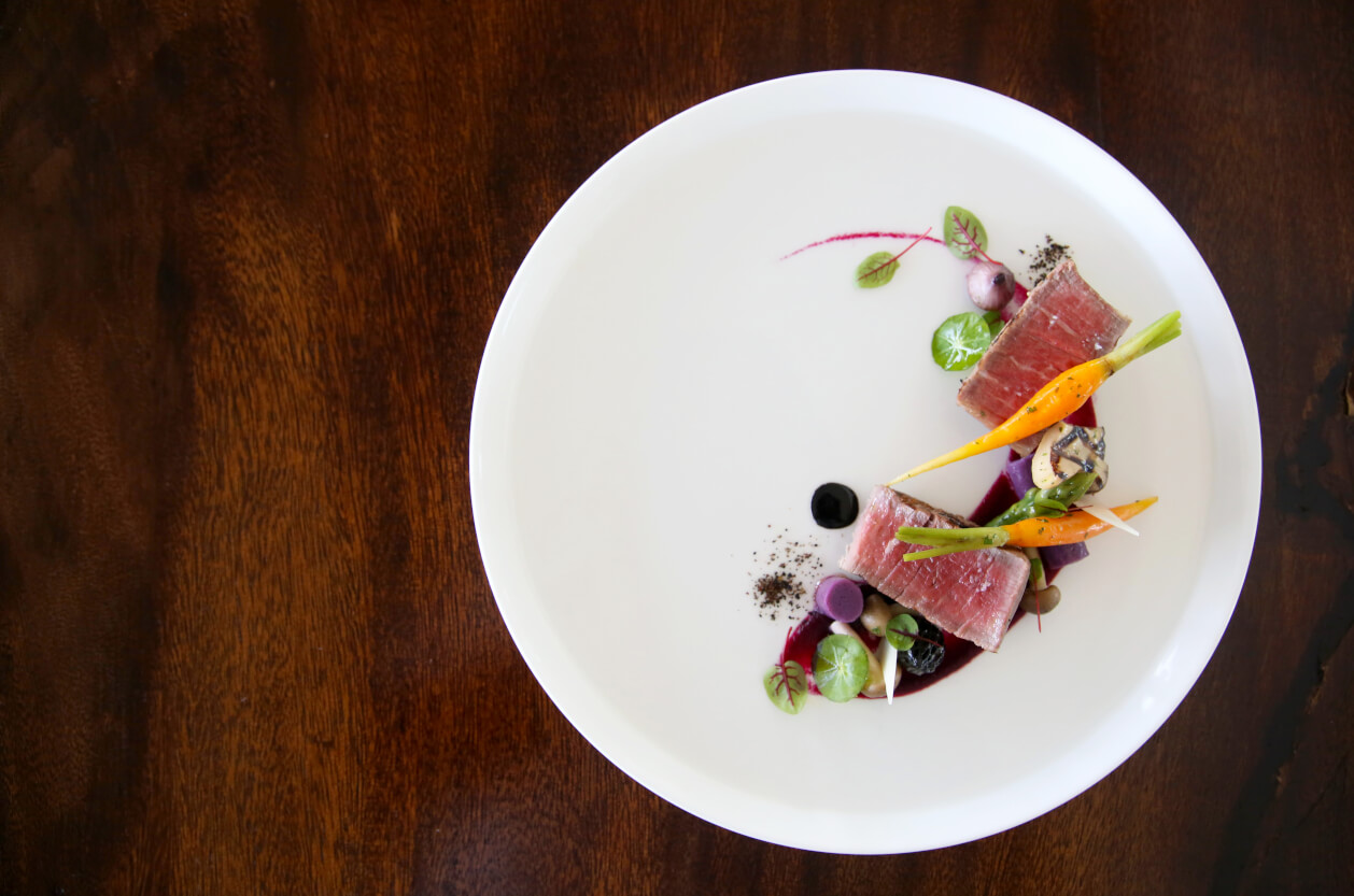 Fillet steak on a white plate with vegetables