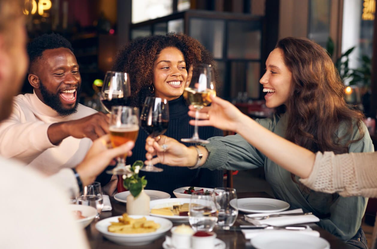 Group of friends socialising with wine