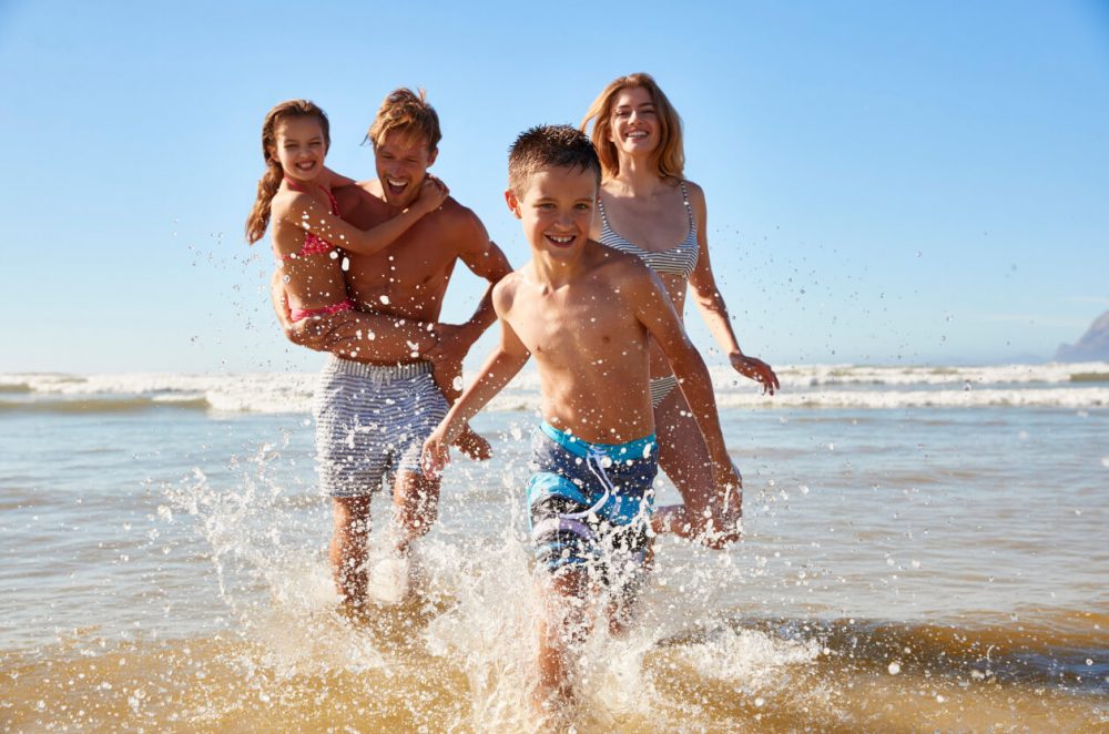 Happy family in paddling in the sea