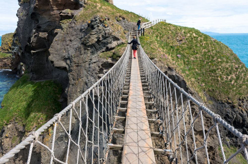 Swinging bridge with rocky mountain beneath